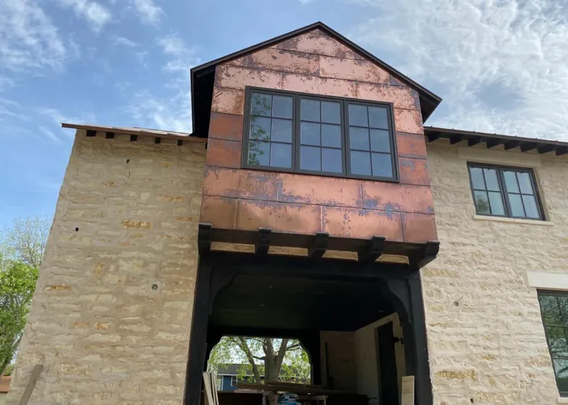 Copper metal panel facade on a stone building for Roof Repair in Rio Rico